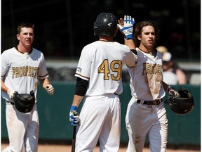 Edmonton Prospects outfielder Travis Hunt congratulates a teammate during a game at Re/Max Field in Edmonton, on Monday, Aug. 5, 2019. The team signed a one-year extension with the city to play at Re/Max Field for 2020.
