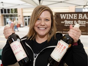 Jessica Stringer with Birds and Bees Organic Winery and Meadery shows a bottle of rhubarb and apple wine at the Edmonton Downtown Farmers Market in Edmonton, on Saturday, Aug. 3, 2019.
