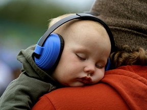 Jude Reeves (15 months old) was lulled to sleep by the music at the 2019 Edmonton Folk Music Festival while in the arms of dad Michael Jensine at Gallagher Park.