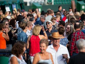 People mingle during Feast on the Field at Commonwealth Stadium on Wednesday, August 14.