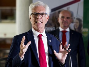 Jim Carr, Minister of International Trade Diversification, makes an education-related announcement as Edmonton Centre MP Randy Boissonnault listens at the University of Alberta on Thursday, Aug. 22, 2019, in Edmonton.