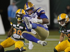 Winnipeg Blue Bombers Andrew Harris makes a leaping reception during Canadian Football League game action against the Edmonton Eskimos in Edmonton on Friday August 23, 2019.