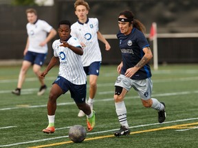 Bassist Steve Harris (right) plays during a friendly soccer game between members of Iron Maiden and FC Edmonton's players, staff and fans at Clarke Stadium in Edmonton, on Thursday, Aug. 29, 2019. The British metal band plays Rogers Place in Edmonton on Aug. 30.