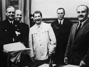 German Nazi Foreign Minister Joachim Von Ribbentrop (L), German Under State Secretary Friedrich Gaus, Soviet head of state Joseph Stalin (3rd) and his Foreign Minister Vyacheslav Molotov (R) pose  Aug. 23 1939 in Kremlin in Moscow after signing the Soviet-German Non-Aggression Pact, or Treaty of Non-aggression between Germany and the Union of Soviet Socialist Republics, making the outbreak of a European war virtually inevitable. After the ceremony, Stalin proposed a toast: "I know how much the German people love their Fuehrer" (Hitler), he said. "I should therefore like to drink to his health".