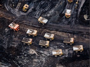 Heavy haulers are seen at the Suncor Energy Inc. Fort Hills mine in this aerial photograph taken above the Athabasca oil sands near Fort McMurray, Alberta, Canada, on Monday, Sept. 10, 2018.