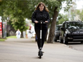 Caitlin Hart tries out a new Bird electric scooter near 102 Street and Jasper Avenue, in Edmonton Friday Aug. 16, 2019. Photo by David Bloom
