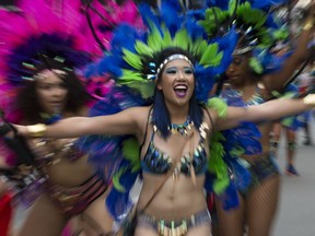 Participants in the Cariwest parade dance their way through downtown.