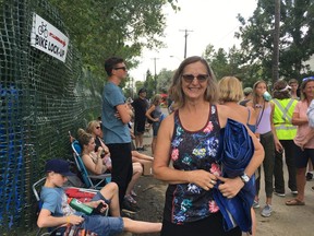 Cathy Bernier holds her tarp at the front of the line for the 40th annual Edmonton Folk Music Festival on Thursday, August 8, 2019. Bernier is first in the queue for a coveted spot to watch the night's performances on the hill in Gallagher Park.