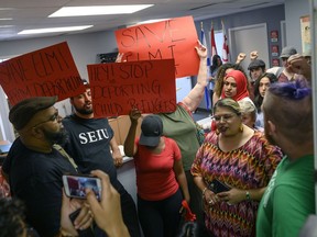 Demonstrators chant in MP Andy Fillmore's constituency office advocating for a stay on the deportation of Abdilahi Elmi to Somalia during a protest in Halifax on Tuesday, August 20, 2019. Included in the group advocating for the stay was Fatuma Abdi, the sister of Abdoul Abdi, the former refugee youth in care who successfully stayed his deportation.