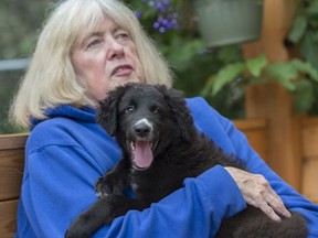 Jan Melnyk with her new 10-week-old puppy Jasper on Friday, Aug. 2, 2019. Her seven-year-old dog Max drowned in the North Saskatchewan River last week. She's now giving out dog lifejackets at Buena Vista off-leash dog park in memory of the dog and wants to raise awareness of dangerous river conditions.