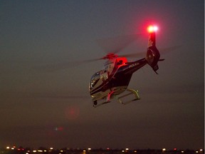 The Edmonton Police Service AIR-2 helicopter lifts off on an evening flight from the City Centre Airport in Edmonton, Alta. File photo.