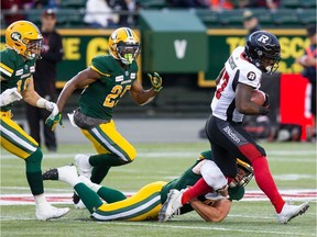 Ottawa Redblacks' DeVonte Dedmon (17) is tackled by Edmonton Eskimos' James Tuck (49) during first half CFL action in Edmonton on Friday, August 9, 2019.