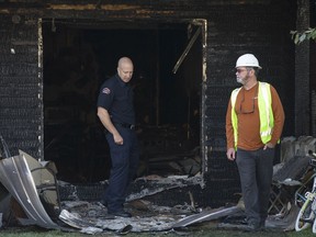 Fire investigators work at the scene of a fire at the Ruby Plaza apartment building, 10106 162 St., in Edmonton Wednesday Aug. 14, 2019. Photo by David Bloom