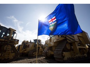 An Alberta provincial flag is surrounded by pipeline heavy machinery at SA Energy Group, in Edmonton Wednesday Aug. 21, 2019.