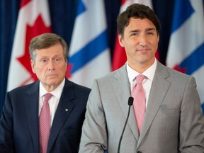 Prime Minister Justin Trudeau (right) stands alongside Toronto Mayor John Tory as he takes questions from journalists following their meeting at Toronto City Hall, on Tuesday August 13, 2019.
