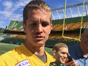 Edmonton Eskimos quarterback Trevor Harris holds up his own Bobblehead that are being sold in advance of Friday's game at Commonwealth Stadium against the Winnipeg Blue Bombers as part of Canadian Armed Forces appreciation night, Aug. 23, 2019.