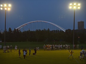 The Edmonton Huskies conducting a practice under the lite up Walterdale Bridge at Kinsmen Park field in Edmonton, August 14, 2019. Ed Kaiser/Postmedia