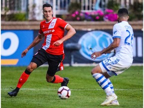 Cavalry FC defender Dominick Zator (4) controls the ball against the Montreal Impact during the second half during the Canadian Championship Semi-final soccer match at Spruce Meadows.