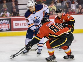 Edmonton Oilers Evan Bouchard and Calgary Flames Zach Osburn fight for the possession of the puck during the battle of Alberta prospects game at Scotiabank Saddledome in Calgary on Tuesday, September 10, 2019. Azin Ghaffari/Postmedia Calgary
