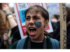 A girl wears face paint as schoolchildren take part in a student climate protest on March 15, 2019 in London, England.