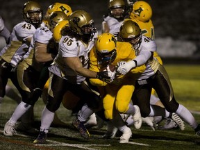 The University of Alberta Golden Bears' Jonathan Rosery (2) is tackled by the University of Manitoba Bisons' Jeremie Drouin (95) and Derek Dufault (40) during the Third Quarter at Foote Field, Sept. 21, 2018.