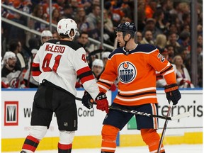 Edmonton Oilers' Kyle Brodziak (28) exchanges words with New Jersey Devils' Michael McLeod (41) during the first period of a NHL game at Rogers Place in Edmonton, on Wednesday, March 13, 2019.