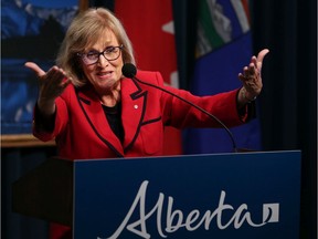 Former Saskatchewan finance minister Janice MacKinnon speaks on the report she chaired on the state of the province's finances at the McDougall Centre in Calgary on Tuesday September 3, 2019. Finance Minister Travis Toews listens in the background. Gavin Young/Postmedia