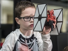 Mason Thomas, 8, was  presented with a 3-D model of his heart that was 3D printed in the form of a Tie Fighter from Star Wars--a special request from the young Star Wars fan on September 11, 2019 at the University of Alberta.  Photo by Shaughn Butts / Postmedia