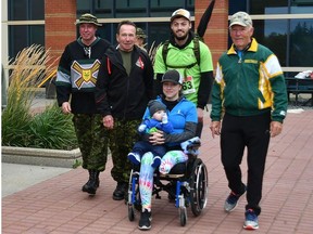 Setting out on the Valour Place fundraising walk last week were, from left to right, Loyal Edmonton Regiment Commanding Officer Lt.-Col. Jonathan McCully; regiment Hon. Col. John Stanton; Tyler Hrycyk pushing wheelchair with partner Amelie Chouinard and their son Milo on board, and Valour Place founder Dennis Erker.