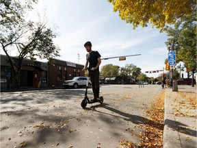 Shane Geary, a driver with Bird Canada, shows how to safely ride a Bird e-scooter along 83 Avenue in Old Strathcona during a press conference in Edmonton, on Tuesday, Sept. 17, 2019. Photo by Ian Kucerak/Postmedia