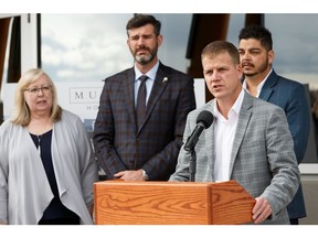 Jason Meliefste, Acting Deputy City Manager, Integrated Infrastructure Services, speaks along with Ward 2 Coun. Bev Esslinger (left), Mayor Don Iveson (centre), and Vic Mutti at the opening of Energy Centre One, the first of the Blatchford community's District Energy Sharing System sites, at the Blatchford site in Edmonton, on Friday, Sept. 20, 2019. Photo by Ian Kucerak/Postmedia