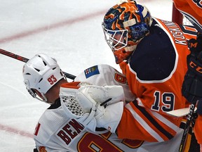 Calgary Flames Sam Bennett (93) slides into Edmonton Oilers goalie Mikko Koskinen (19) during pre-season NHL action at Rogers Place in Edmonton, September 20, 2019. Ed Kaiser/Postmedia