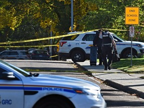 Yellow tape surrounds a scene where RCMP investigate an officer-involved shooting at a residence along Pine Street in Sherwood Park on Monday, Sept. 23, 2019.