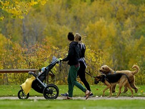 Two young mothers take a stroll against a colourful background of autumn leaves at Hawrelak Park in Edmonton on Tuesday September 24, 2019.