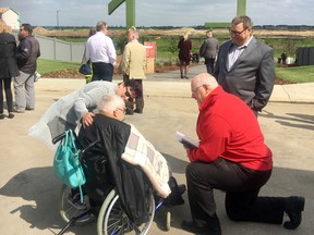 Russell Dauk, in the red coat, from Rohit Communities, talks with Second World War veteran and POW Gordon King at the naming ceremony for the Gordon King Pond in the Arbours of Keswick. Dauk was inducted into the BILD Alberta Hall of Fame for his long volunteer commitments with the organization.