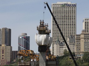 Construction crews work on the Valley Line LRT bridge across the North Saskatchewan River, in Edmonton Sunday July 14, 2019.