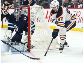 Edmonton Oilers forward Tomas Jurco (92) attempts a wrap around against Winnipeg Jets goalie Connor Hellebuyck (37) during the first period at Bell MTS Place.