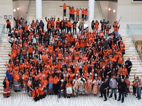 Particpants pose for a group photo on Orange Shirt Day which is an opportunity to participate in an activity supporting reconciliation at city hall in Edmonton on Friday, Sept. 27, 2019. Orange Shirt Day is an outcome of the 2013 Joseph Mission Residential School Commemoration Project and Reunion in Williams Lake, B.C., where Phyllis Webstad spoke of how her new orange shirt was taken away, and how it seemed that nobody cared.