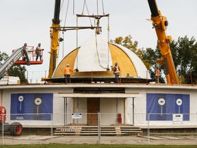 Crews install the dome during the reconstruction of the Queen Elizabeth Planetarium at Coronation Park in Edmonton, on Monday, Sept. 23, 2019. Photo by Ian Kucerak/Postmedia