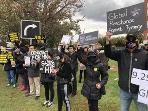 Demonstrators lined Gateway Boulevard near Whyte Avenue to show solidarity with pro-democracy protestors in Hong Kong on Sunday, Sept. 29, 2019.