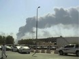 In this Saturday, Sept. 14, 2019 file photo, made from a video broadcast on the Saudi-owned Al-Arabiya satellite news channel, smoke from a fire at the Abqaiq oil processing facility fills the skyline, in Buqyaq, Saudi Arabia. The weekend drone attack on one of the world's largest crude oil processing plants that dramatically cut into global oil supplies is the most visible sign yet of how Aramco's stability and security is directly linked to that of its owner -- the Saudi government and its ruling family.