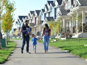 Christopher and Arrianna Lamoureux take a walk in SouthPointe with their children Atlas, 4, and Leonidas, four months old.