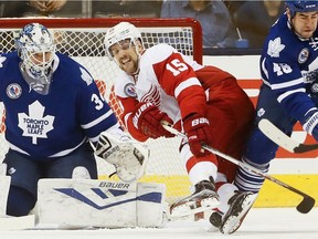 Leafs Roman Polak and Red Wings Riley Sheahan fight for the puck in front of James Reimer as the Toronto Maple Leafs take on the Detroit Red Wings at the Air Canada Centre in Toronto on Dec. 31, 2000.