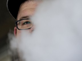 Richard Szabo with Vape Crave, 8411 109 St., exhales as he vapes outside the store, in Edmonton Monday Sept. 9, 2019. Photo by David Bloom