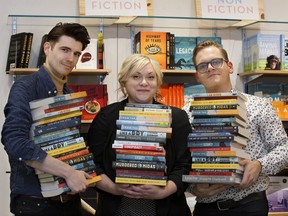 Glass Bookshop co-owner Jason Purcell (left), executive director of LitFest Fawnda Mithrush, and Glass Bookshop co-owner Matthew Stepanic hold books by authors at this year's LitFest.