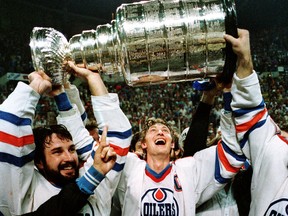 Wayne Gretzky and a bearded Paul Coffey hoist the Stanley Cup on May 19, 1984, the first-ever Cup victory for the Edmonton Oilers.