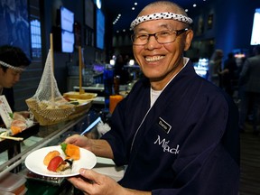 David Okumiya with Mikado serves sushi during a media reveal of new food and beverage options for Rogers Place at Studio 99 in Edmonton on Thursday, Oct. 3, 2019.
