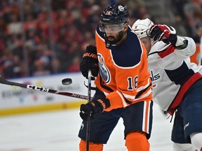 Edmonton Oilers forward Jujhar Khaira eyes the puck in front of Washington Capitals defenceman Dmitry Orlov during NHL action at Rogers Place in Edmonton on Oct. 24, 2019.