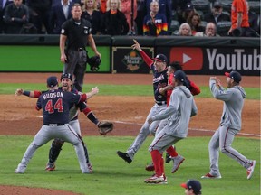 Nationals pitcher Daniel Hudson (44) and catcher Yan Gomes (10) celebrate after defeating the Houston Astros in Game 7 of the 2019 World Series at Minute Maid Park.