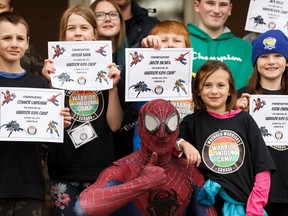 Kids get their completion certificates during a ceremony with Spider-Man at Wounded Warriors Canada Warrior Kids Camp at Camp Van-es near Sherwood Park on Sunday, Oct. 13, 2019. The program is a two-day camp for 25 kids aged 8-16 whose parent is a veteran or a first-responder living with an operational stress injury, such as post-traumatic stress disorder.